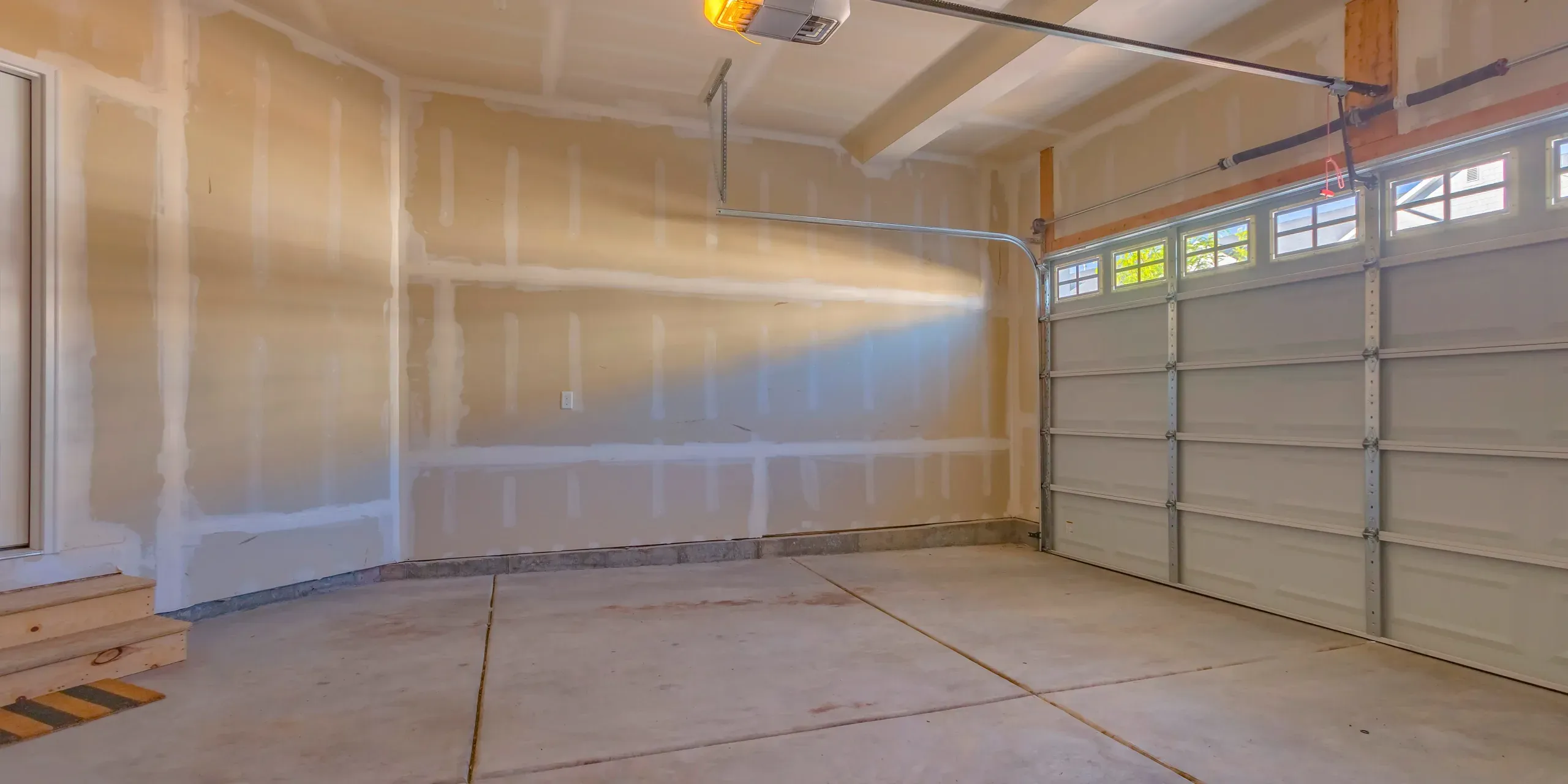 Fire-rated drywall assembly installed across a garage wall and ceiling