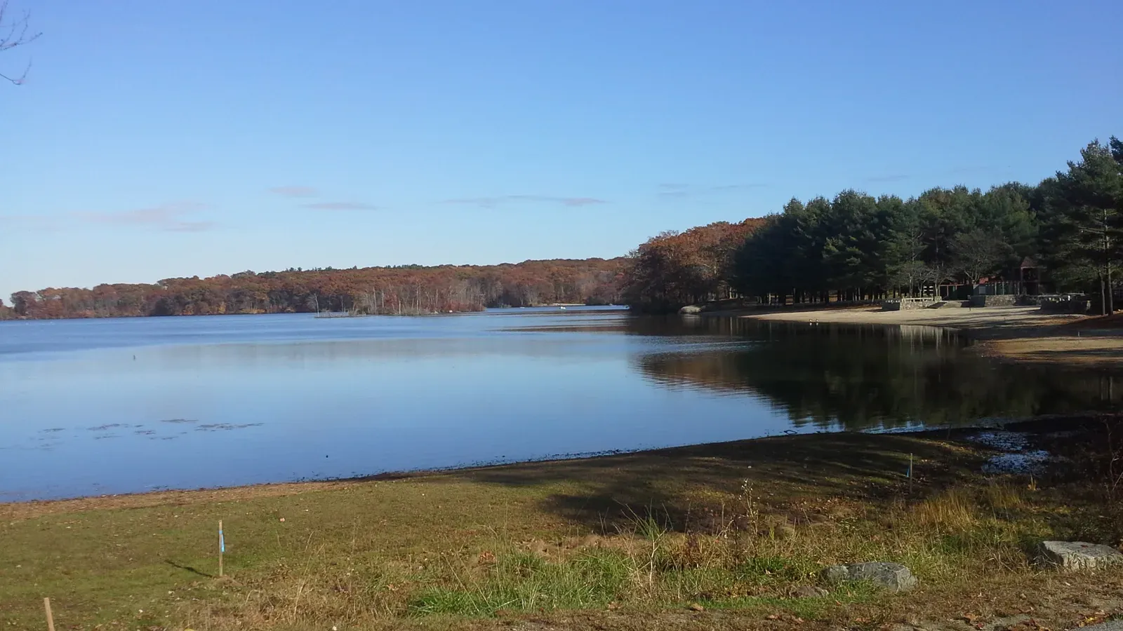The tree-lined pond and shoreline at Lincoln Woods State Park in autumn, Lincoln, Rhode Island